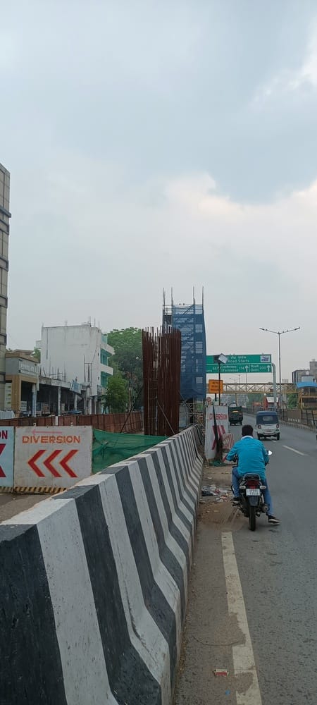 The metro track will cross the highway from Kamala Nagar; pillars have been constructed on both sides.