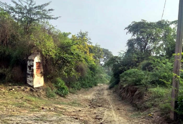 Holipura's streets lie in disrepair, waterlogging in the paths, in the hope of restoration.