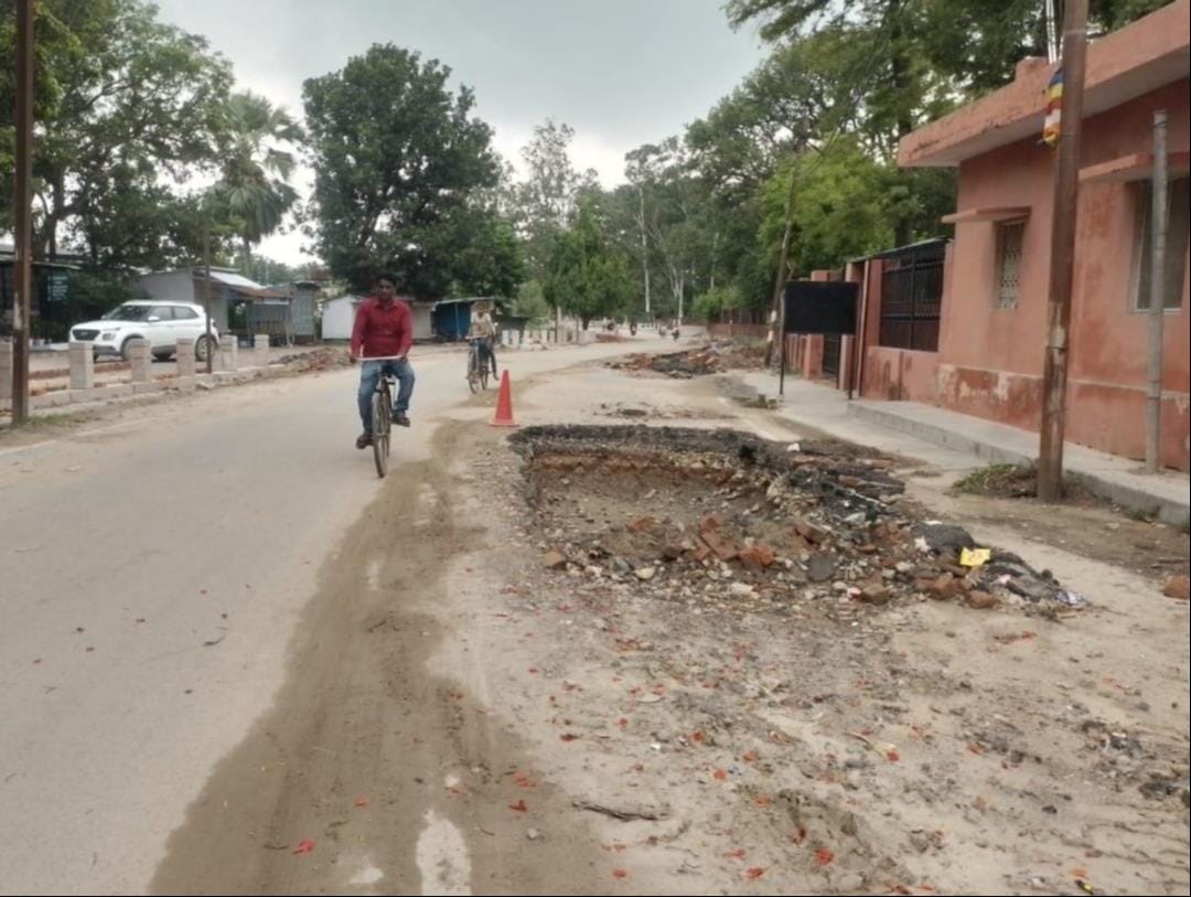 Potholes marring the image of the sacred site; tourists inconvenienced.