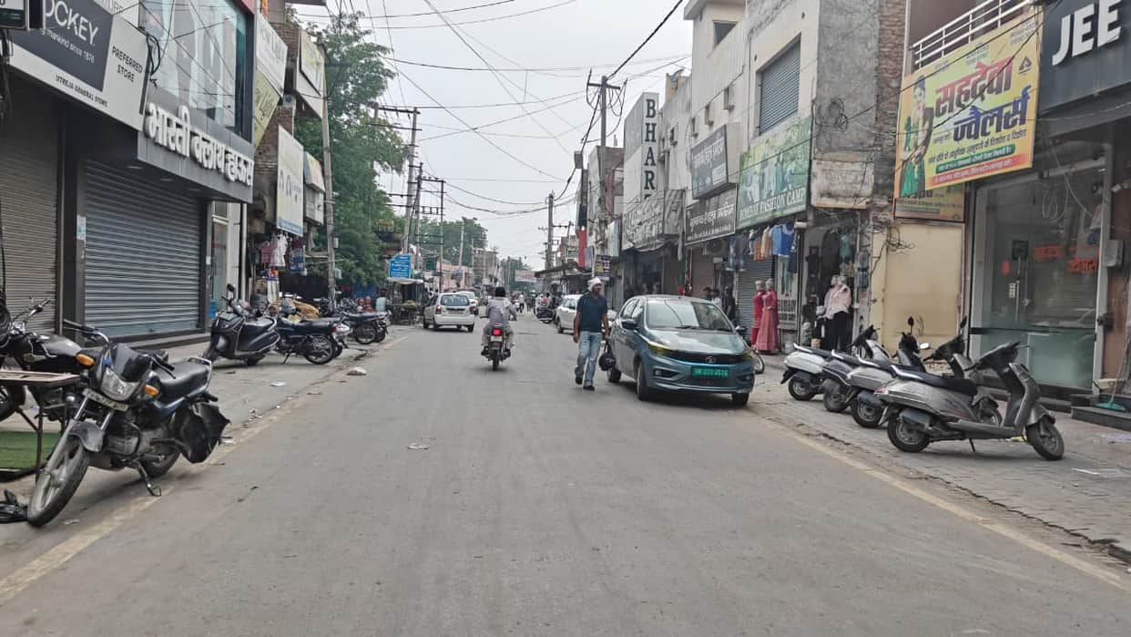 Vehicles parked beyond the yellow line have increased congestion in the main market
