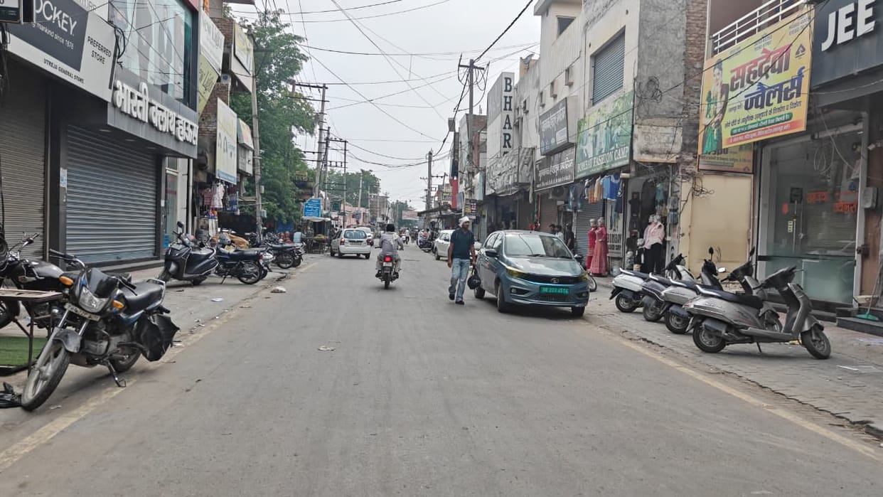 Vehicles parked beyond the yellow line have increased congestion in the main market