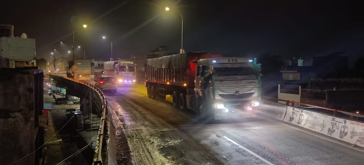 Noisy dumper trucks on the overbridge all night; looming risk of accidents.