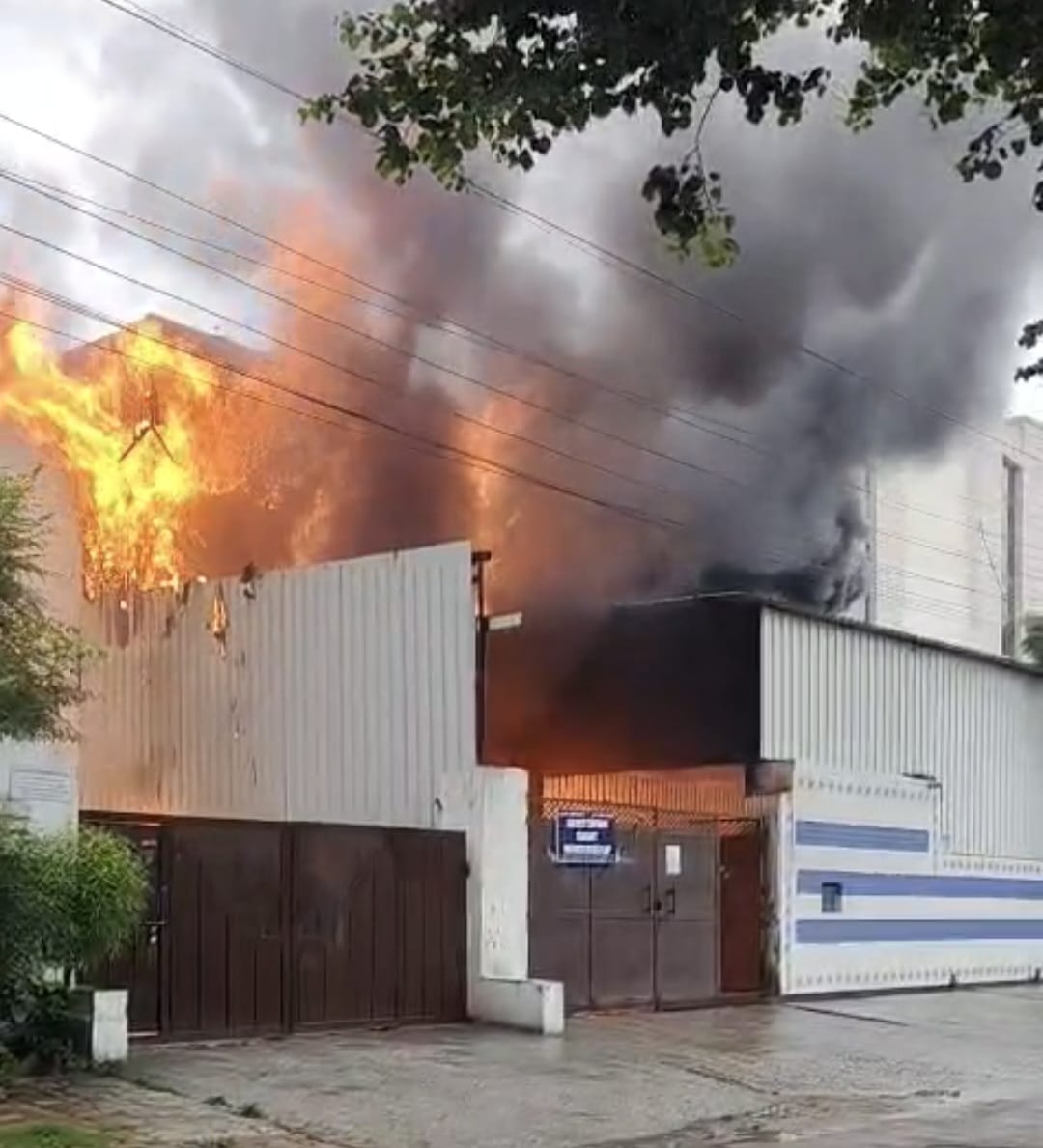 Fire breaks out at a lighter manufacturing factory and spreads to two others; chemical drums explode.
