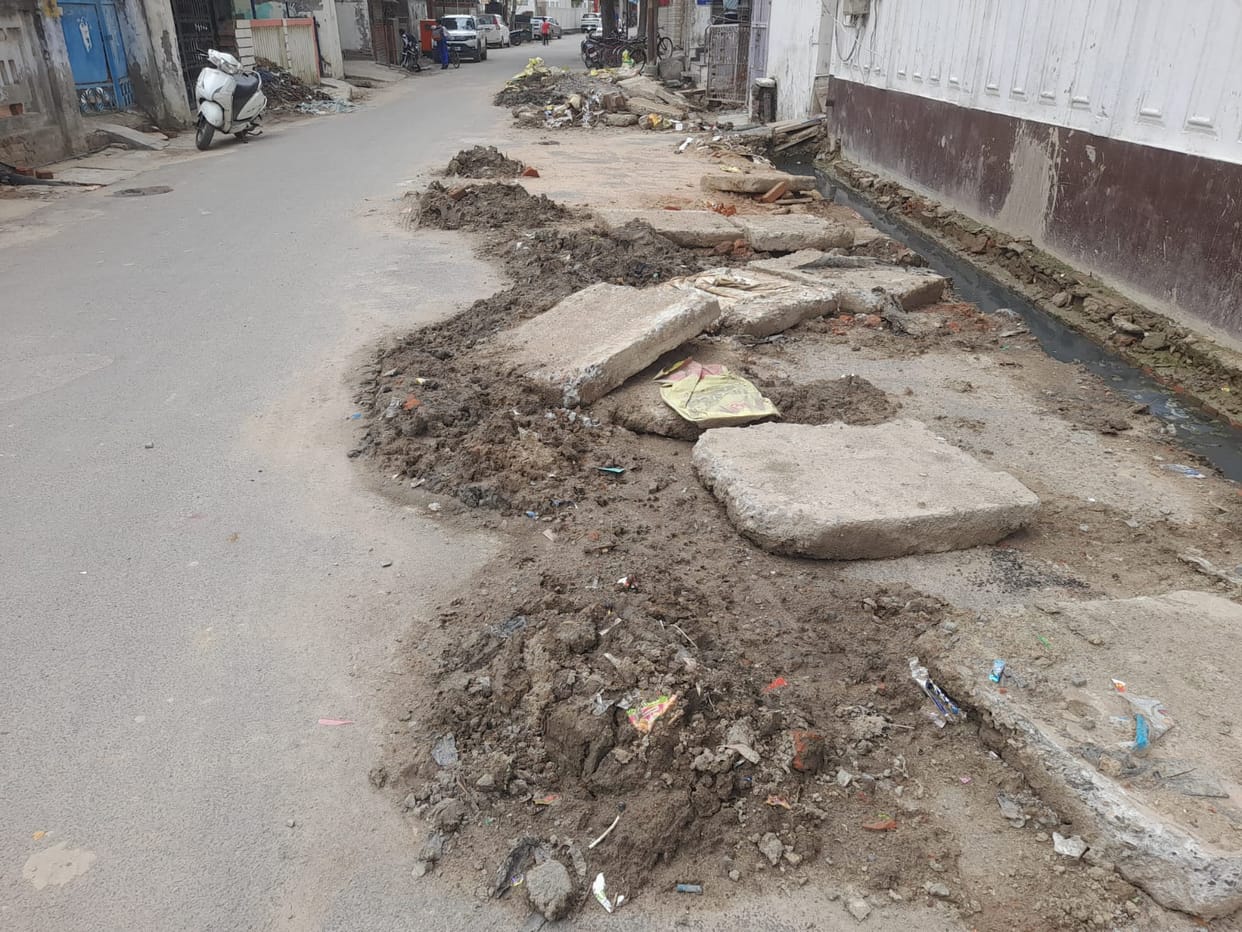 Municipal sanitation workers cleaned the drain, dumped the silt on the road, and left.