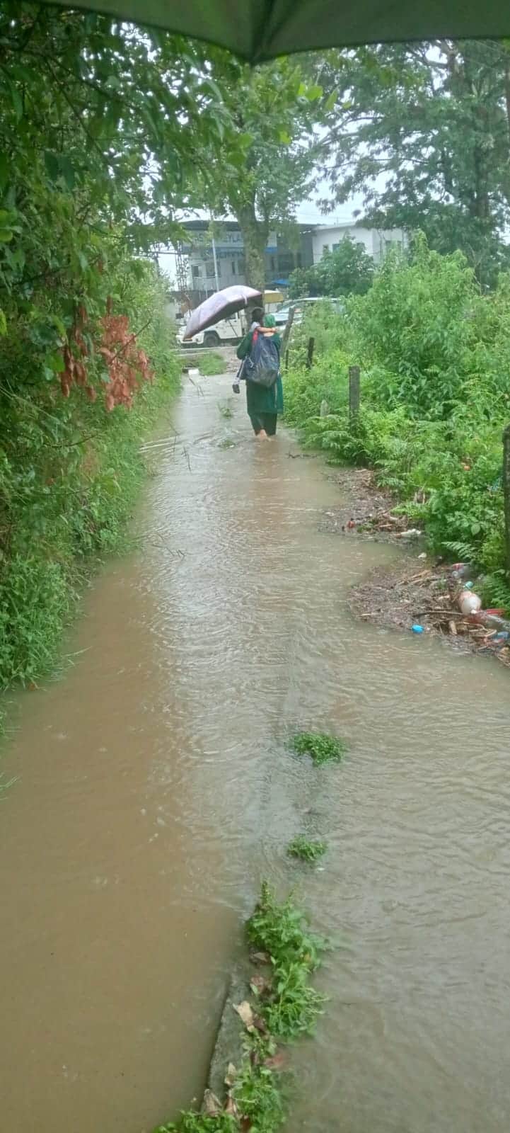 Water backed up at the culvert; the road is getting submerged.