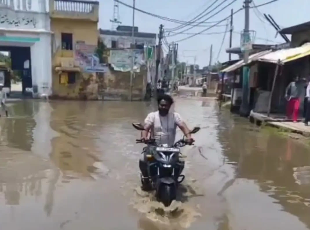 Rainwater has accumulated in front of the main madrasa in Mundali.