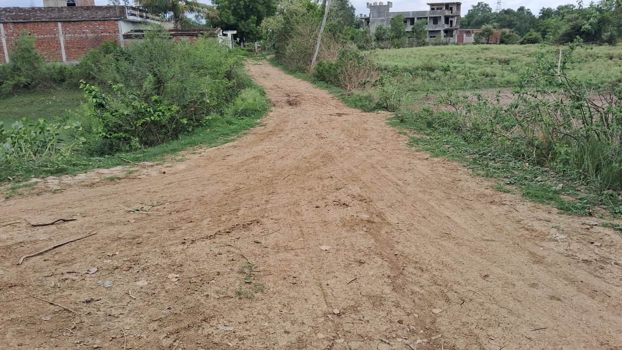 The hospital got its own building but lacks an access road; patients are forced to wade through 300 meters of mud
