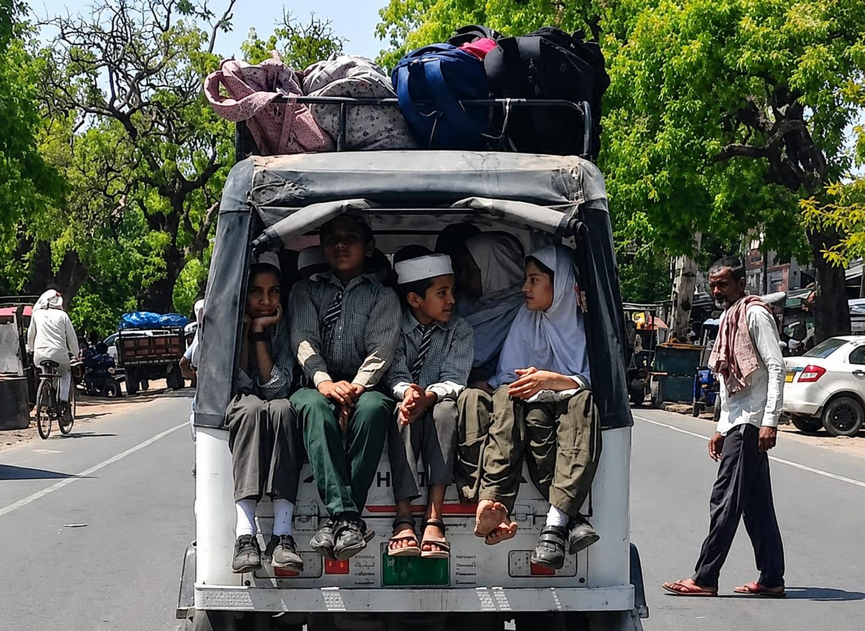 Children are being packed into private vehicles to be taken to school.