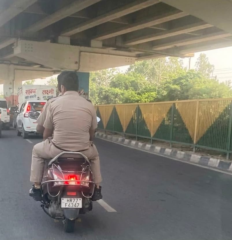Questions raised about police personnel not wearing helmets.