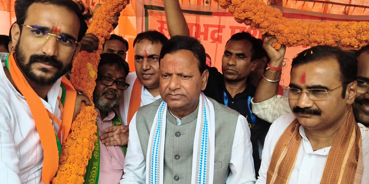 Flowers showered from a bulldozer; welcomed with the presentation of a mace