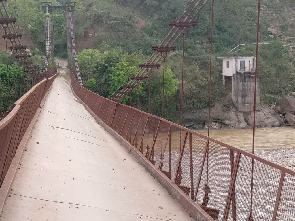 Bridge over Neugal Khad tilted to one side.