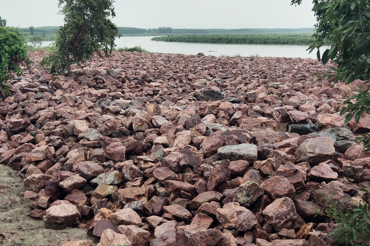 Work on strengthening embankments disrupted by rain.