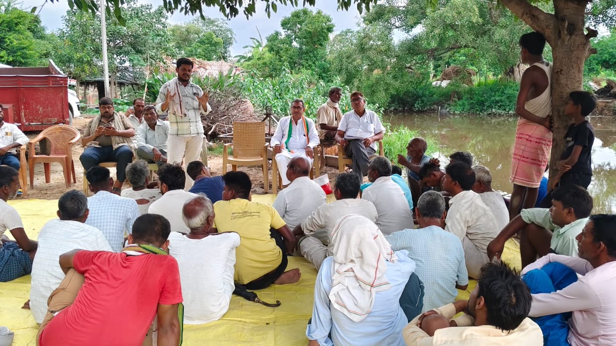 Farmers hold village meeting to protest land acquisition; warn against voting.