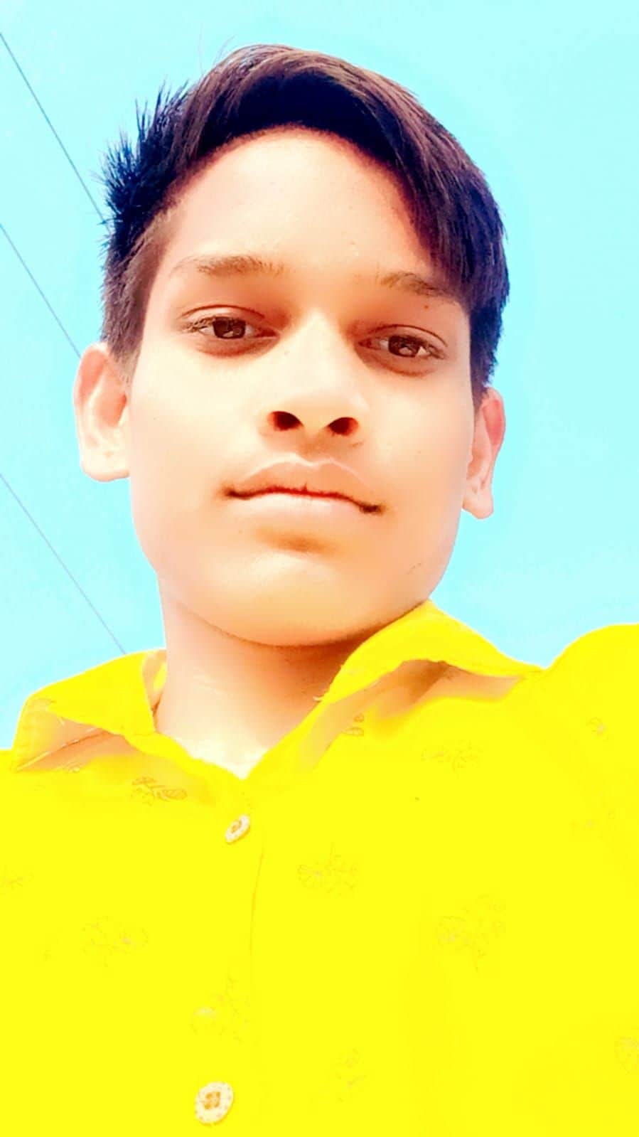 Youth electrocuted by power line passing over roof; dies.
