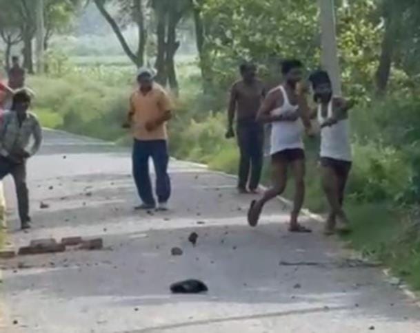 10 injured as two groups clash violently with sticks and clubs over a drainage dispute.