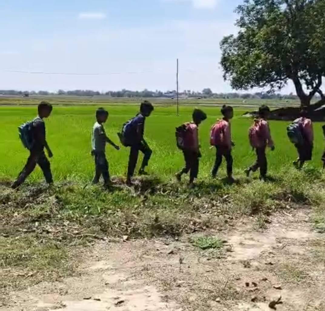 Paved road plans gathering dust in officials' files; over 500 students struggle through mud to reach school.