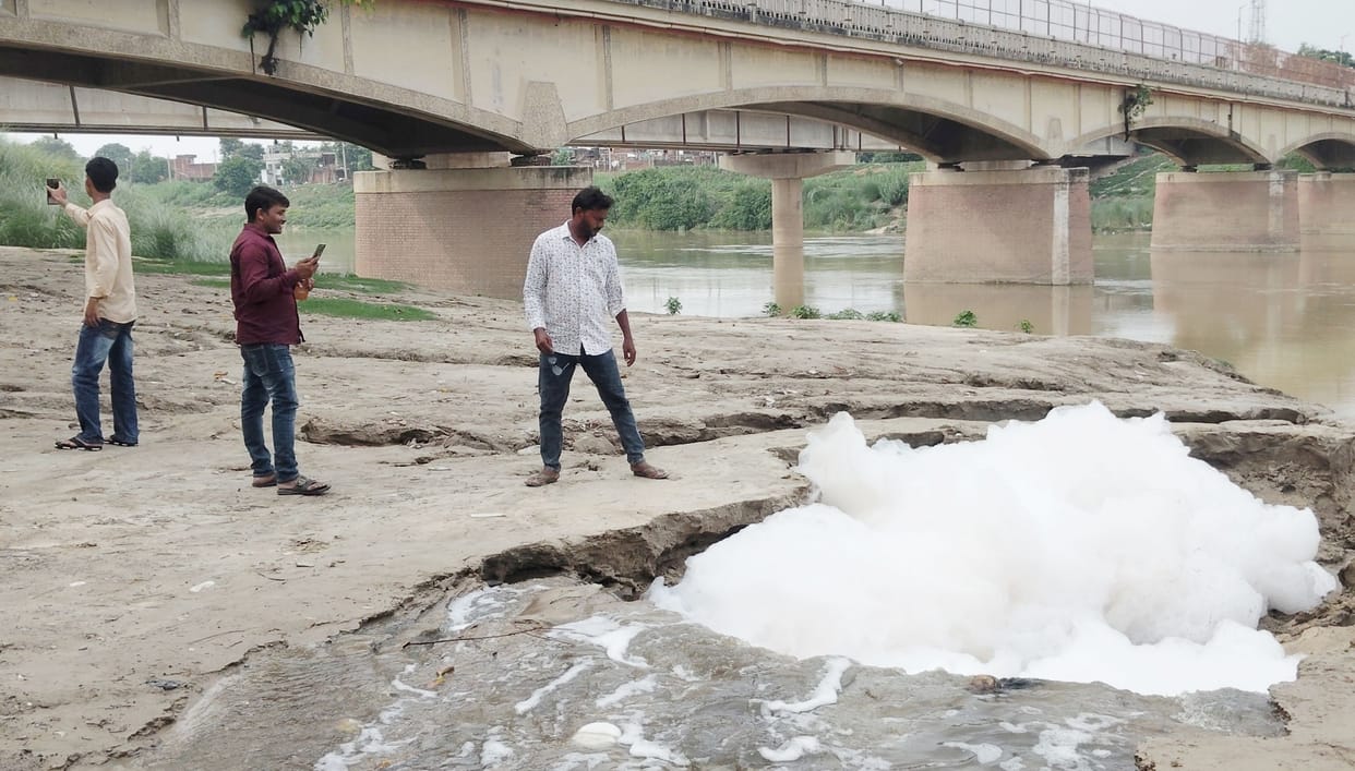 Drain water flowing into the Rapti; foam exposes the extent of pollution.