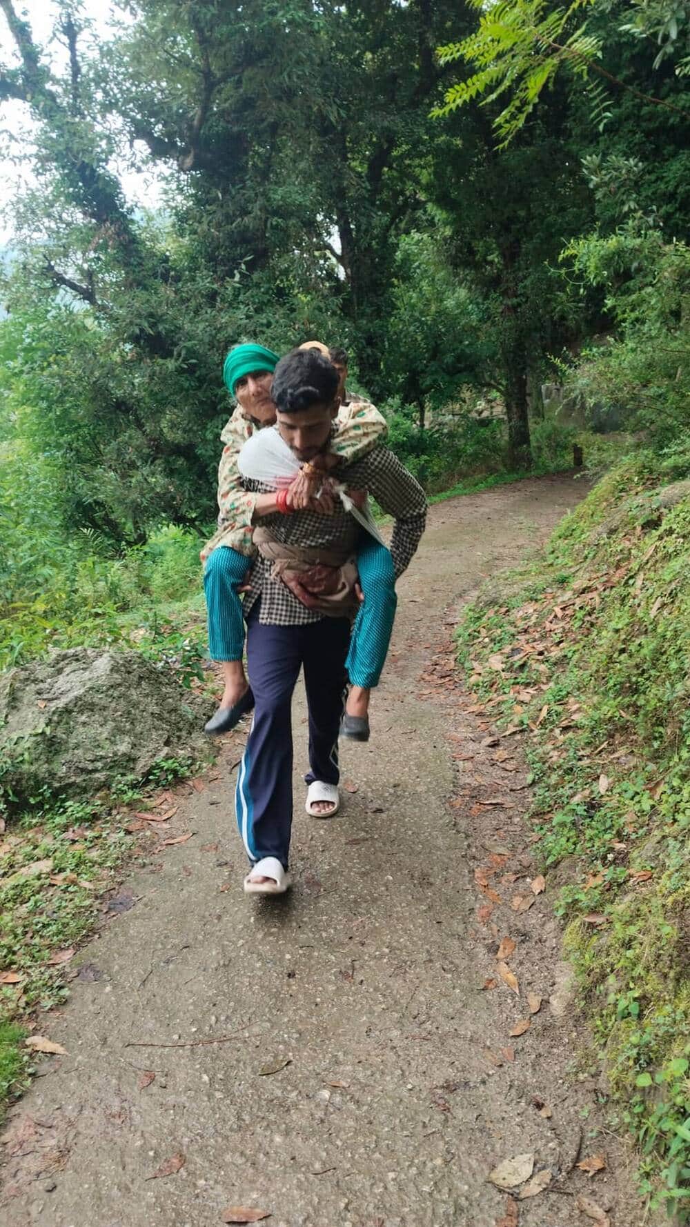 In Kandara village, a patient was carried on the back to the road.