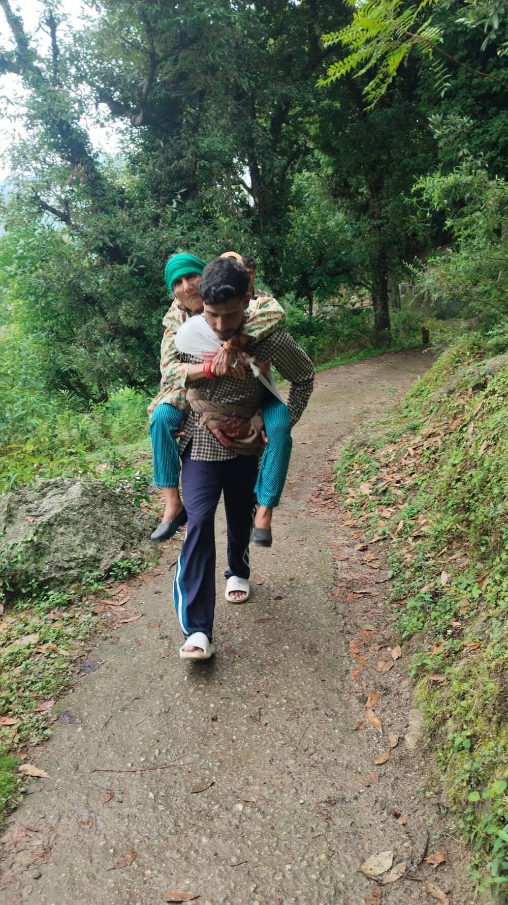 In Kandara village, a patient was carried on the back to the road.