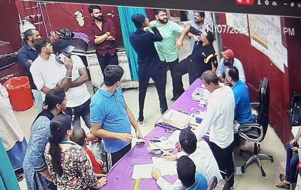 Hospital staff protest against the assault on a sanitation worker in the emergency ward