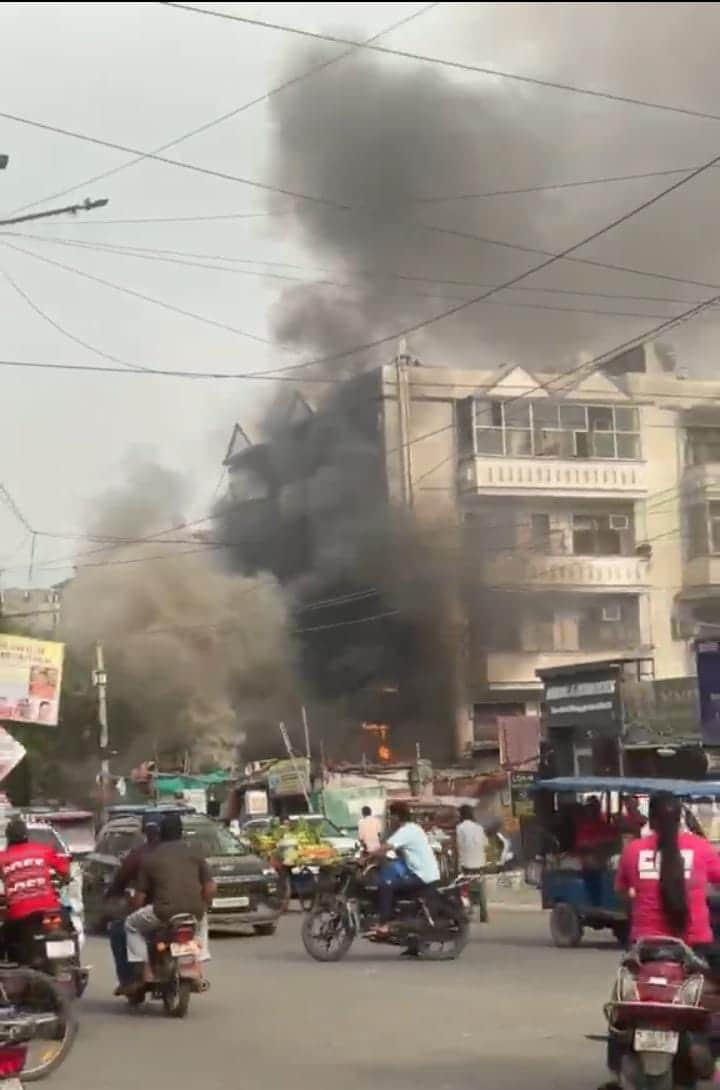 Fire erupts in the electric chimney of a sidewalk restaurant.