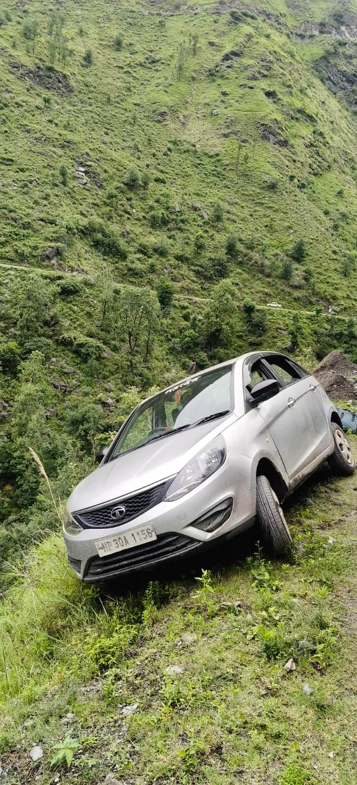 Car dangles over the edge of a gorge on the Bagheigarh-Chanju road.