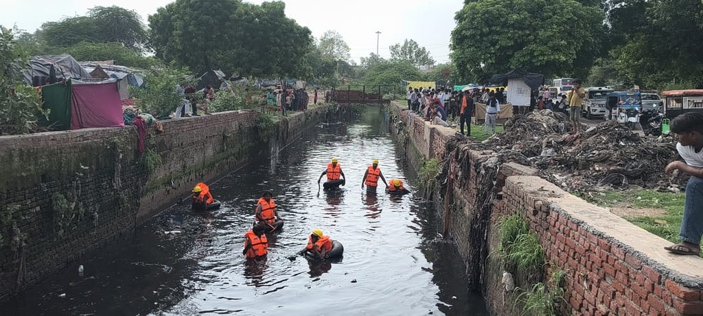 Municipal Corporation deployed 40 more divers into the drain; no trace of the elderly woman.