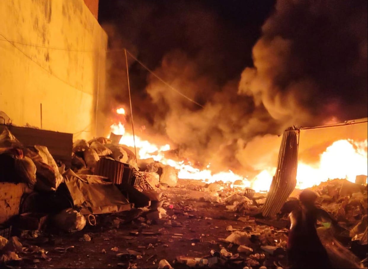 Massive fire at a scrap warehouse in a residential area; explosions spark panic.