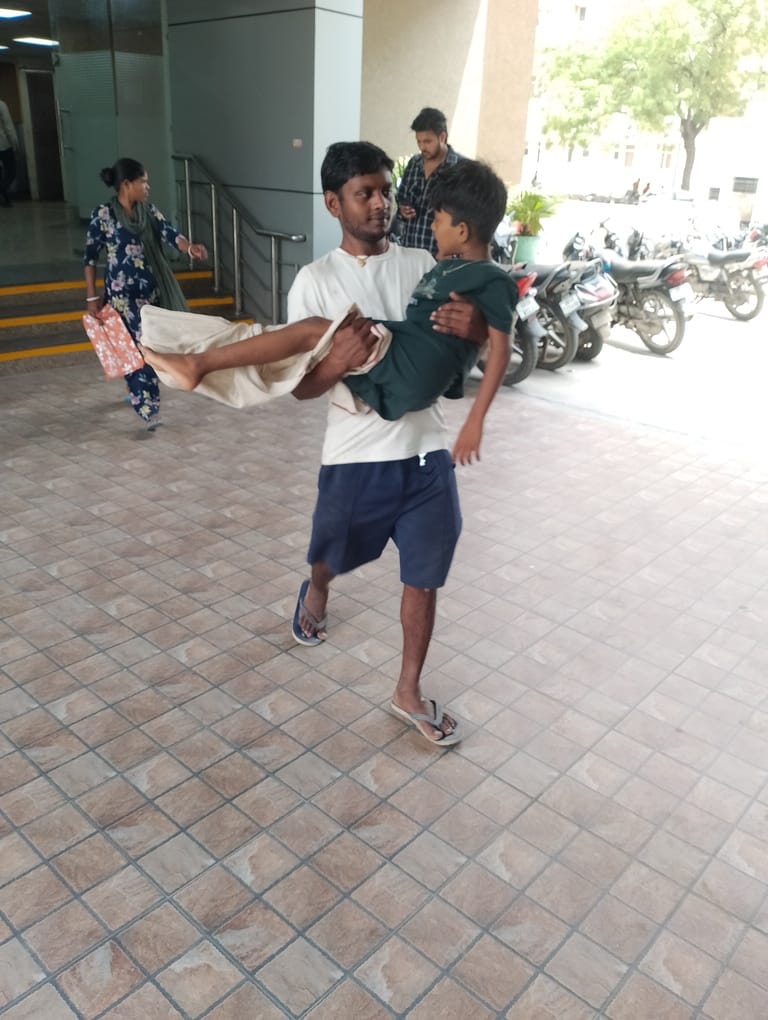 The father was compelled to carry his son in his arms from the OPD to the X-ray room.