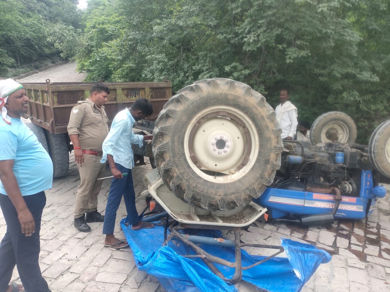 Tractor overturns while descending a hill due to brake failure.