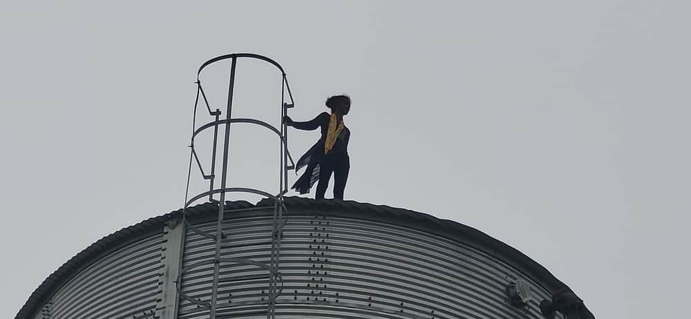 Young woman climbs 80-foot-high water tank to meet her lover.