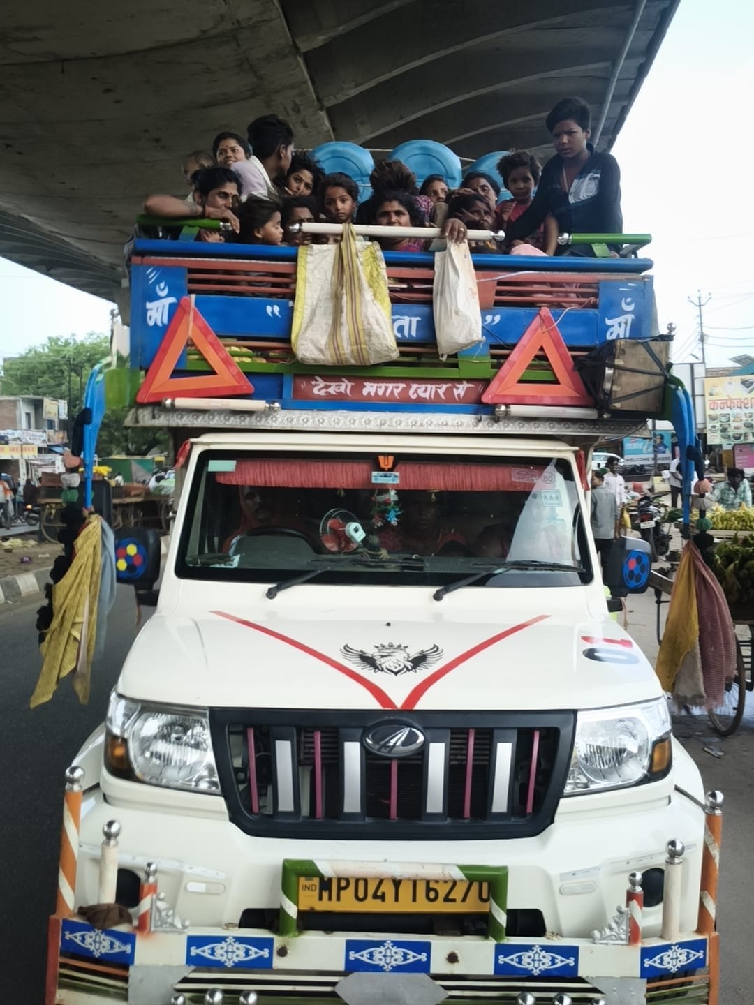 Challan issued for pickup truck carrying 30 people.