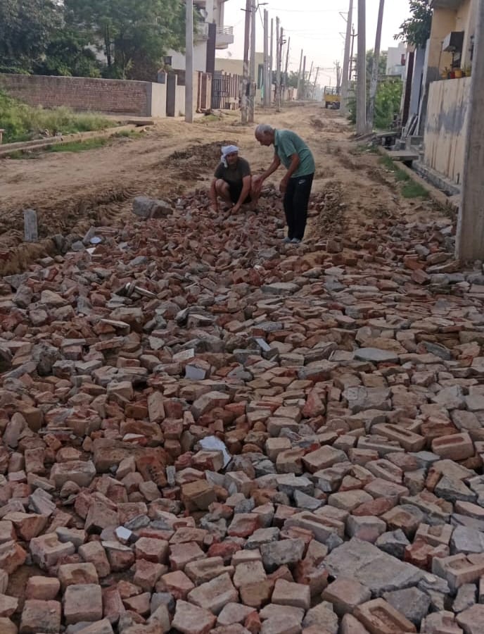Residents of Ward 13, troubled by mud, laid bricks themselves to create a path.