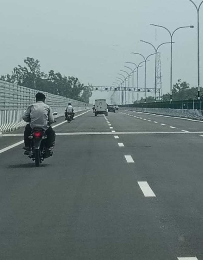 Two friends on a motorcycle rode onto the newly constructed expressway despite the ban