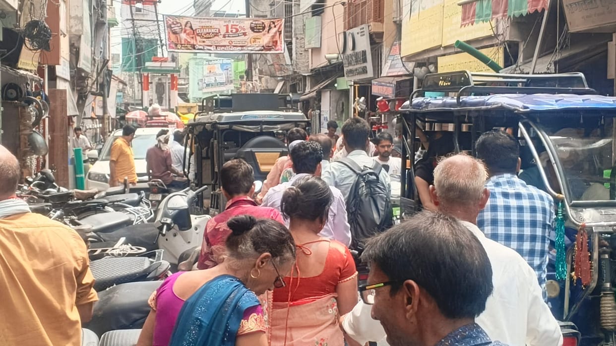 Four-wheelers entering markets despite the ban; pedestrians in distress.