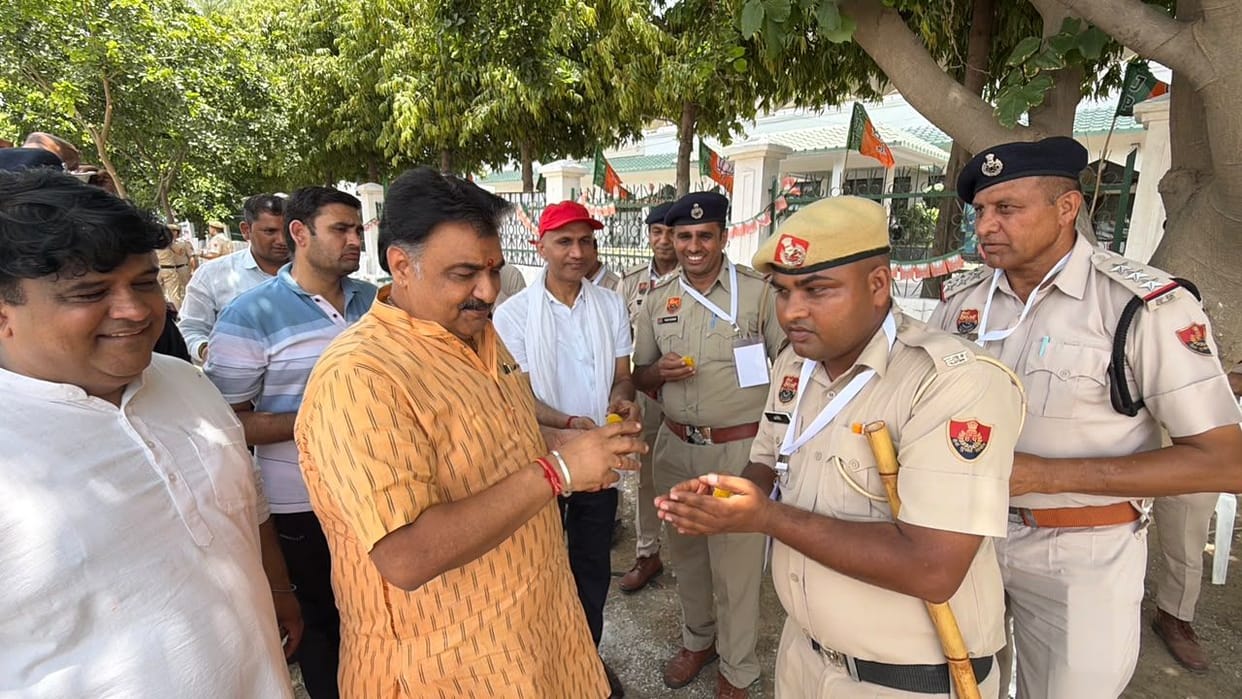 The Deputy Speaker honored the security personnel by feeding them laddus.