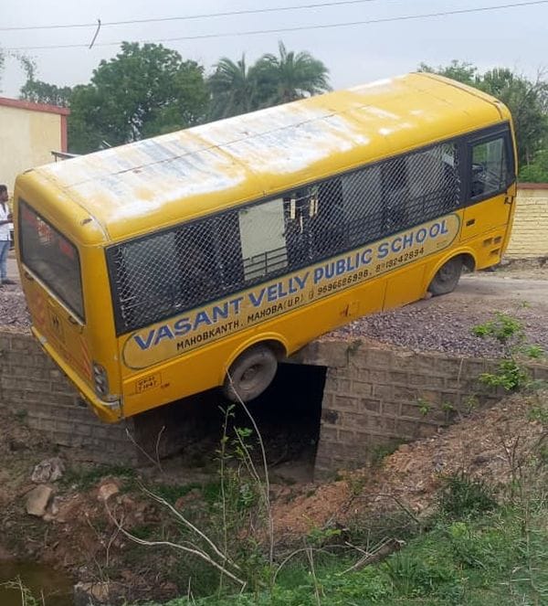 School bus dangles from culvert; villagers rescue children.