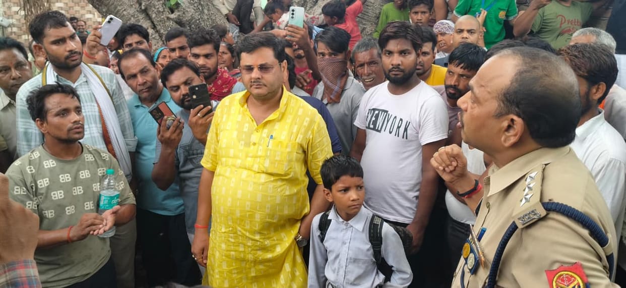 Man climbs mobile tower with children, alleging harassment by relatives and the police.