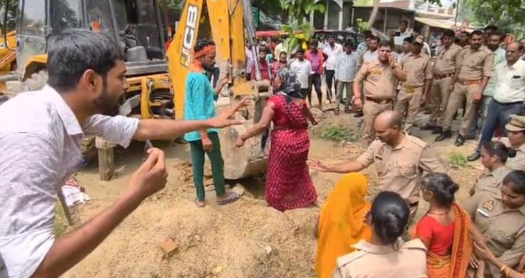 शनिवार को अकबरपुर के मानस नगर कॉलोनी में अतिक्रमण हटाने गई जेसीबी के सामने प्रदर्शन करती महिलाए