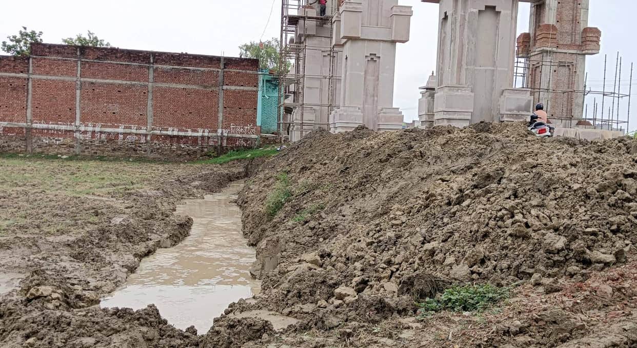 Development work involving the forcible extraction of soil from farmers' fields.