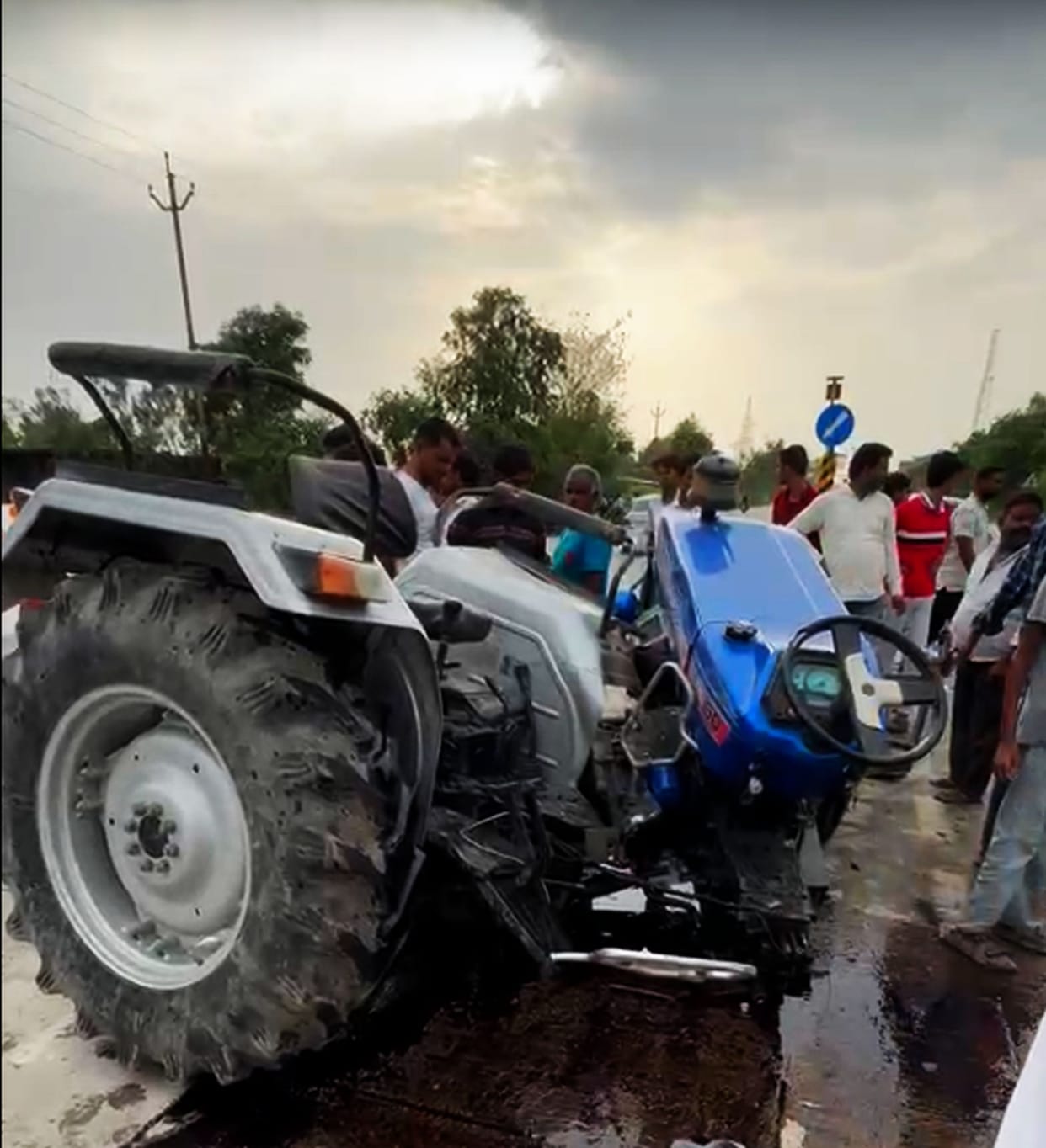 Tractor overturns at turn and collides with DCM truck; four injured.