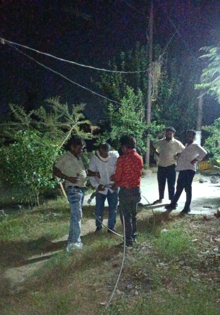 नगर के चांदपुर रोड पर रात के समय टूटे तार को ठीक करते कर्मचारी। संवाद