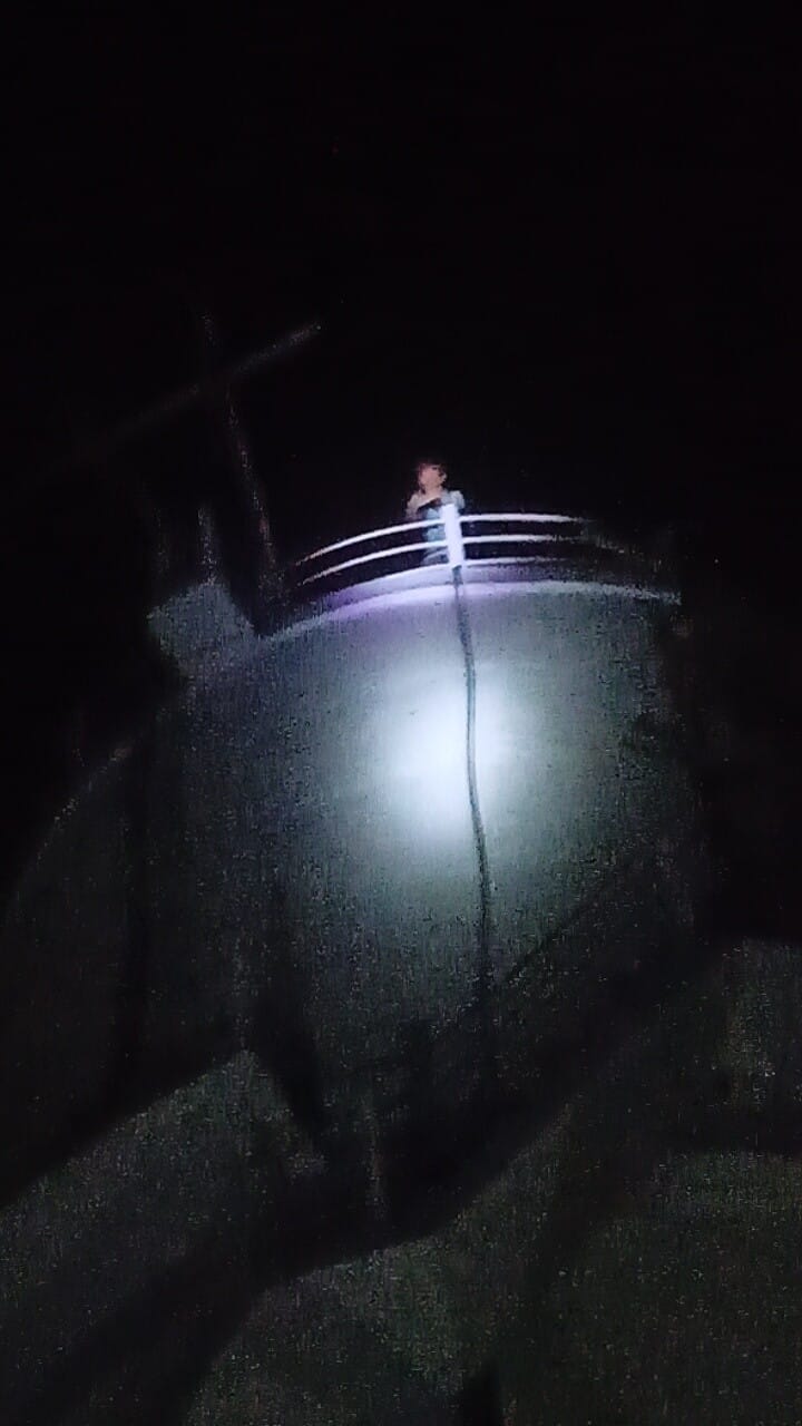 Young man's stunt on water tank; claims wife's family isn't sending her back.