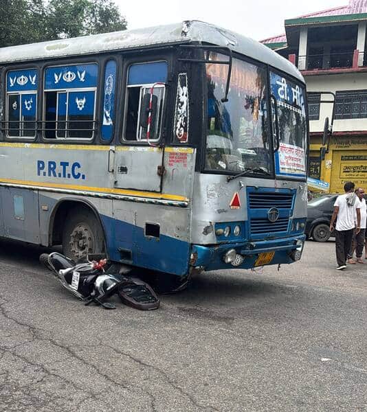 नाल्टी पुल चौक पर पंजाब रोडवेज की बस के नीचे आई स्कूटी। -स्त्रोत : जागरूक पाठक।