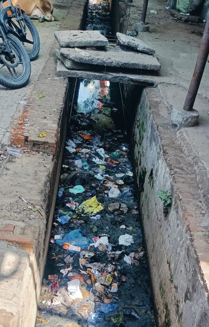 No lighting at the roadways bus stand; open drain also poses an accident risk.