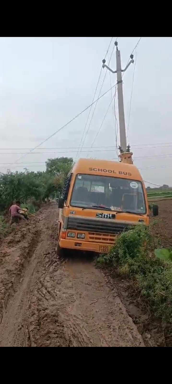 School bus skids on mud on road, hits electric pole