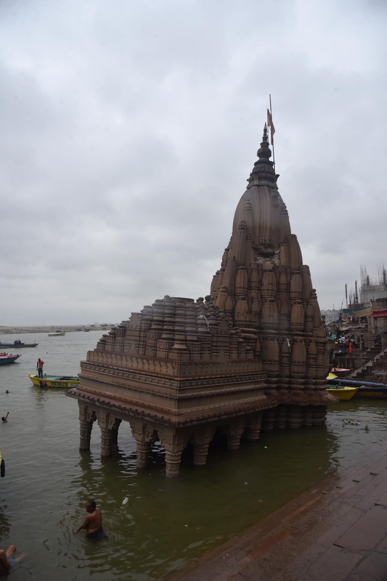 Preparations are underway to relocate the decorative frills, lights, banners, canopies, and even the *Aarti* site.