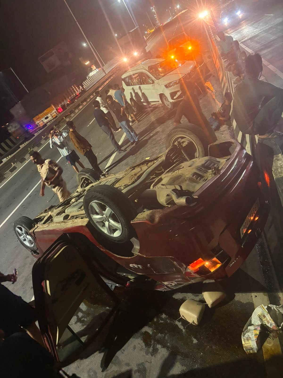 Two speeding cars collide, one overturns