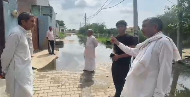 Pond overflows after light rain; water enters homes.