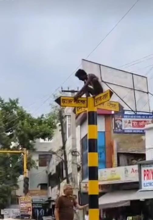 Cleaner climbed a pole; brought down after a 20-minute struggle.